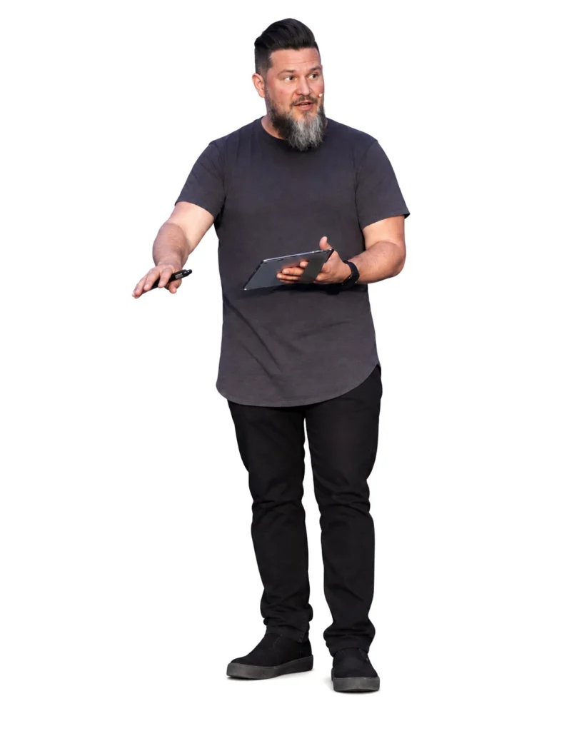 Brian Drinkwine speaking, gesturing toward his audience with a tablet in hand